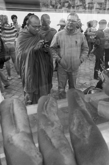 CAMBODIA. Phnom Penh. 24/01/2014: But Bunthen, from the Independent Monks Network, Human Rights Activist, and Chan Vichet, former Dey Krohom community leader, wait for the start of a commemorative ceremony at the place the Dey Krohom was violently evicted from on this same day in 2009.