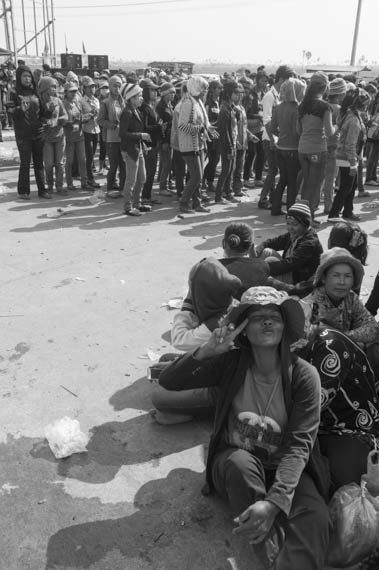 CAMBODIA. Dangkor (Phnom Penh). 28/01/2014: Workers dancing while waiting for their representatives to meet with the managers when about 1000 garment factory workers at the industrial area of Vattanac II walked out after 11 union leaders were fired.