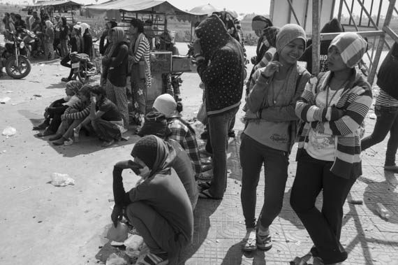 CAMBODIA. Dangkor (Phnom Penh). 28/01/2014: Workers waiting for their representatives to report on the negotiations with the direction when about 1000 garment factory workers at the industrial area of Vattanac II walked out after 11 union leaders were fired.