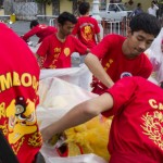 CAMBODIA. Phnom Penh. 30/01/2014: Group celebrating Chinese New Year at the Royal Palace wrapping up the lion's heads.