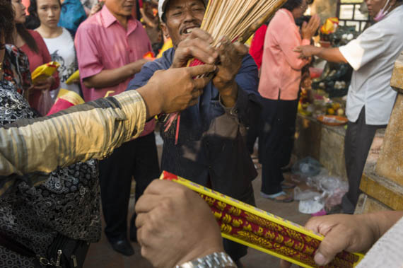 CAMBODIA. Phnom Penh. 31/01/2014: Revellers celebrate Chinese New Year at pagoda on top of Wat Phnom.