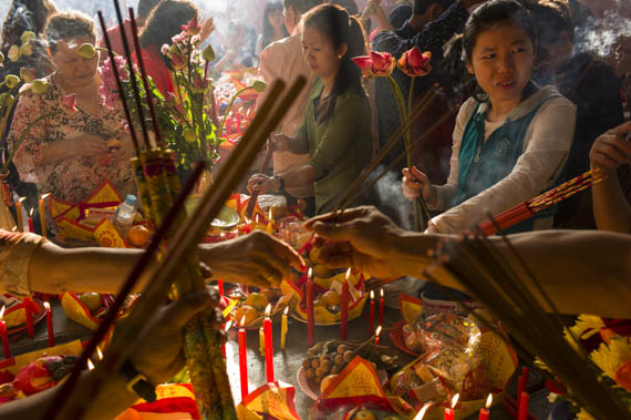 CAMBODIA. Phnom Penh. 31/01/2014: Revellers celebrate Chinese New Year at pagoda on top of Wat Phnom.