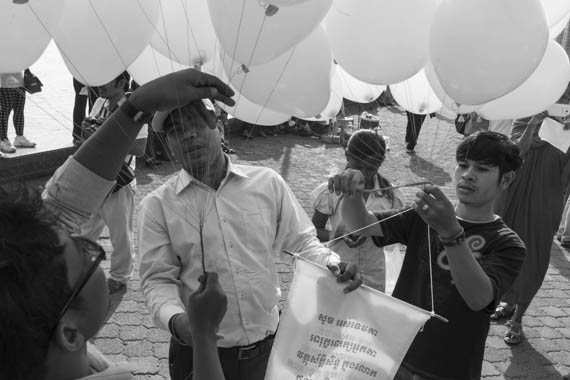 CAMBODIA. Phnom Penh. 7/02/2014: Balloons being released by members of the Civil Society Organisations (CSO) who, together with 23 monks from the Independent Monk Network for Social Justice (IMNSJ), demonstrate and pray at Preah Ang Dongker pagoda for the release of 23 people jailed after the violent crackdown of striking workers on January 2nd and 3rd.