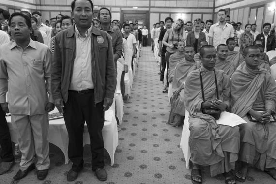 CAMBODIA. Phnom Penh. 10/02/2014: Ath Thun, Coalition of Cambodian Apparel Workers' Democratic Union (CCADWU) leader, singing the cambodian national anthem ahead of a march to the Preah Ang Dong riverside pagoda, members of various unions hold a meeting in a conference room of the Imperial Hotel. A whole series of simultaneous events were organised, both in Cambodia and in front of Cambodian embassies abroad, one day ahead of the appeal hearing to grant bail to 21 of the 23 people jailed during the violent crackdown by the army on striking workers this early january.