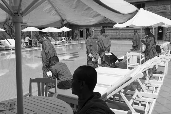 CAMBODIA. Phnom Penh. 10/02/2014: Monks waiting next to the swimming pool until the meeting of various unions finishes, ahead of a march to Preah Ang Dong riverside pagode. A whole series of simultaneous events were organised, both in Cambodia and in front of Cambodian embassies abroad, one day ahead of the appeal hearing to grant bail to 21 of the 23 people jailed during the violent crackdown by the army on striking workers this early january.