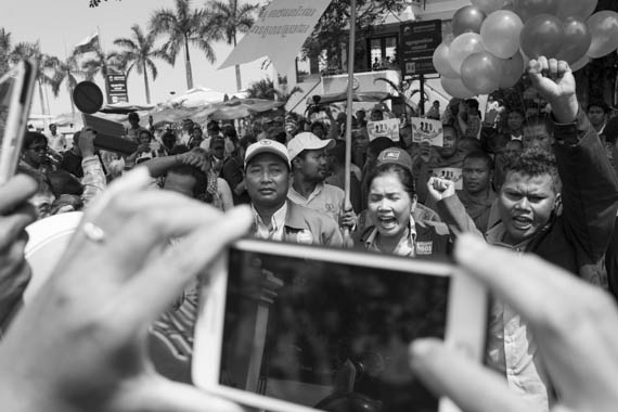 CAMBODIA. Phnom Penh. 10/02/2014: Ath Thun, Coalition of Cambodian Apparel Workers' Democratic Union (CCADWU) leader, and other union leaders leading a march of about 300 people towards Preah Ang Dong riverside pagoda. A whole series of simultaneous events were organised, both in Cambodia and in front of Cambodian embassies abroad, one day ahead of the appeal hearing to grant bail to 21 of the 23 people jailed during the violent crackdown by the army on striking workers this early january.