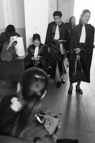 CAMBODIA. Phnom Penh. 11/02/2014: Lawyers wait for the hearing to start while workers and supporters demonstrate outside the Appeals Court where the judges will decide on a request for bail for 21 workers, activists and union leaders arrested during the violent crackdown of a workers strike on January 2nd and 3rd.