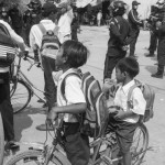 CAMBODIA. Phnom Penh. 5/02/2014: Schoolchildren looking at municipality guards during the negotiations with CINTRI workers, in charge of the garbage collection of Phnom Penh, on their third day of a strike about their wage of 75$US per month.