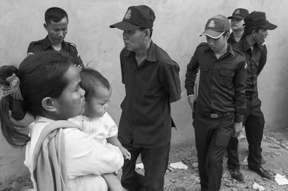 CAMBODIA. Phnom Penh. 12/02/2014: Communal Security Guards try to stop the inhabitants from the Borei Keila community which was evicted in January 2012 and had to live in unhealthy shacks near a building they were promised an appartment in, to occupy the empty building.