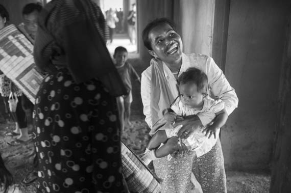 CAMBODIA. Phnom Penh. 12/02/2014: Inhabitant from the Borei Keila community which was evicted in January 2012 and had to live in unhealthy shacks near a building they were promised an appartment in, happy to have taken possession of a lot in the empty building.