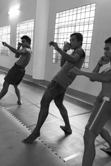 CAMBODIA. Phnom Penh. 20/02/2014: Manou Phuon, Choreographer, rehearsing a new piece inspired by khmer boxing with Amrita Performing Arts dancers, here coached by Him Saran, a professional boxer.