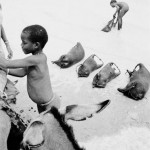 BURKINA FASO. Tin Akoff. 6/03/1985: Filling guerbas with water at a pond close to the malian border.