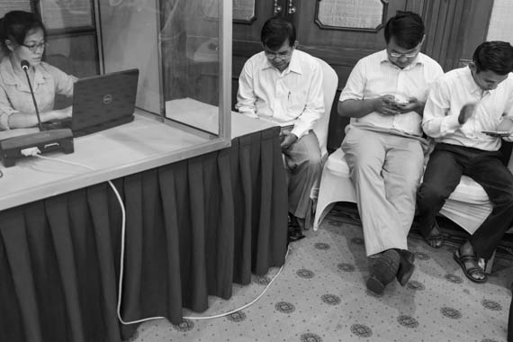 CAMBODIA. Phnom Penh 7/03/2014: Participants checking their smartphone before a workshop with civil society groups organised by the CNRP at the Imperial Garden Hotel.