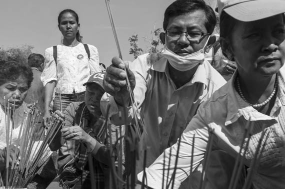 CAMBODIA. Phnom Penh 30/03/2014: People praying at the memorial for the victims from the 1997 grenades attack on a political rallye of 200 Sam Rainsy Party supporters during which 16 people were killed and more than 100 wounded.