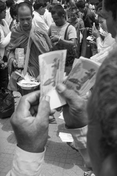 Hig CAMBODIA. Phnom Penh 30/03/2014: CNRP supporters giving alms to monks at the commemoration of the 1997 grenades attack on a political rallye of 200 Sam Rainsy Party supporters during which 16 people were killed and more than 100 wounded.