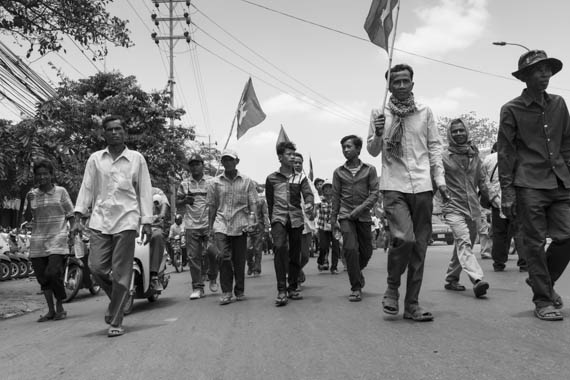 CAMBODIA. Phnom Penh 30/03/2014: CNRP supporters march to the party headquarters after the commemoration ceremony for the 1997 grenades attack on a political rallye of 200 Sam Rainsy Party supporters during which 16 people were killed and more than 100 wounded.