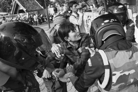 CAMBODIA. Phnom Penh 5/03/2014: Members from the former Boeung Kak Lake are arrested in front of City Hall while waiting for a group of land rights activists who plan to deliver an invitation to a ceremony for Women's Day.