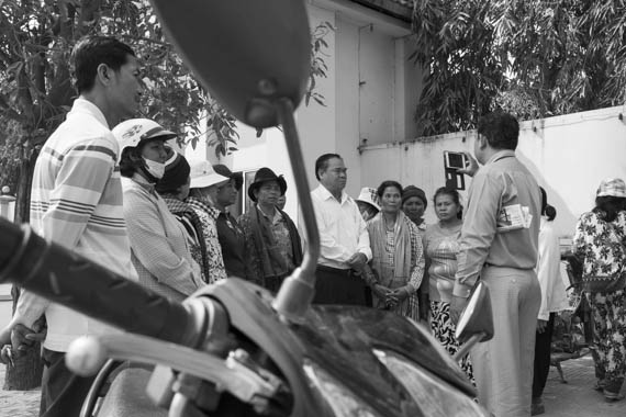 CAMBODIA. Phnom Penh 5/03/2014: Ho Vann, CNRP lawmaker, with members of the former Boeung Kak Lake community at the Phnom Penh police station waiting for the release of three members of the community who were arrested earlier that day when trying to deliver an invitation to a ceremony for International Women's Day.