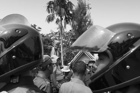 CAMBODIA. Phnom Penh 5/03/2014: Boeung Kak Lake land rights activists challenging the police to arrest them by climbing on a municipality truck when trying to deliver an invitation to a ceremony for International Women's Day.