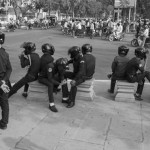 CAMBODIA. Phnom Penh. 8/03/2014: Municipal security guards take a rest after having dispersed onlookers and journalists to prevent a public forum organised by labour unions to be held at Freedom Park on International Women's Day.