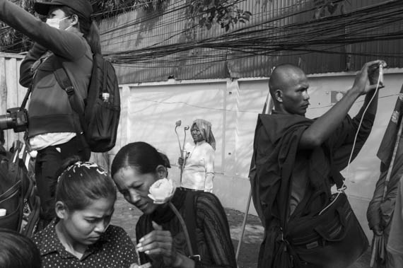 CAMBODIA. Phnom Penh. 8/03/2014: Members from Boeung Kak lake and Borei Keila, joined by monks from the Independent Monk Network for Social Justice (IMNSJ) are prevented by riot police to march to the Ministry of Women's Affairs to deliver a petition on International Women's Day.