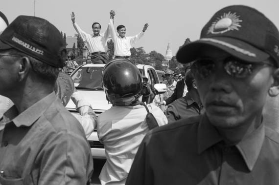 CAMBODIA. Phnom Penh. 8/03/2014: Sam Rainsy and Kem Sokha, co-presidents of the opposition CNRP, after a short supportive visit to workers when authorities prevent a public forum organised by labour unions to be held at Freedom Park on International Women's Day.