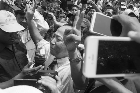 CAMBODIA. Phnom Penh. 8/03/2014: Mam Sonando, director of Beehive radio, addresses the crowd when authorities prevent a public forum organised by labour unions to be held at Freedom Park on International Women's Day.