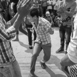 CAMBODIA. Phnom Penh 13/03/2014: Workers at the E.Z. International Garment Factory dance in front of the factory to the sound of house music when on a strike to protest the non observance of labour laws by the management.