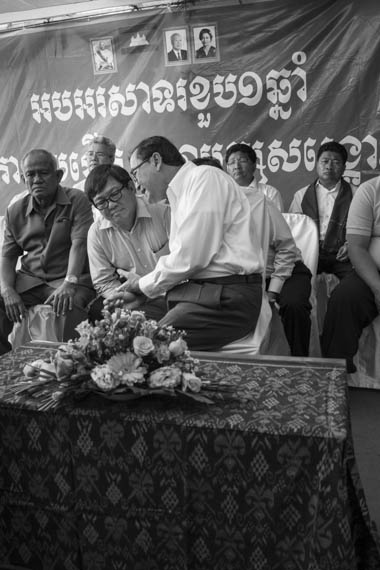 CAMBODIA. Phnom Penh 7/04/2014: Son Chhay, CNRP lawmaker, chats with Sam Rainsy, CNRP co president, at the start of the ceremony for the 1st anniversary of the creation of the opposition CNRP, a merger between the Sam Rainsy Party the Human Rights Party, at the party headquarters. Son Chhay is involved in the negotiations with the ruling CPP to resolve the deadlock which followed the 2013 legislative elections.