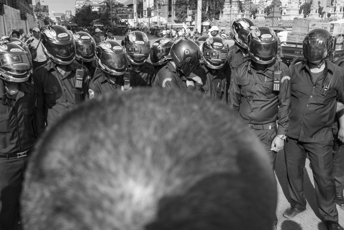 CAMBODIA, Phnom Penh. 20/05/2014: Scuffle between monks and Municipality Security Guards at the beginning of a demonstration near the Phnom Penh Municipality Court during the trial of 23 workers and union leaders arrested during the violent crackdown on striking workers which resulted in 6 strikers killed on January 3rd.