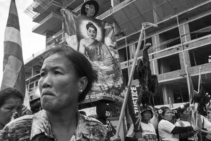 CAMBODIA, Phnom Penh. 20/05/2014: Demonstration with dead chicken used for a cursing ceremony near the Phnom Penh Municipality Court during the trial of 23 workers and union leaders arrested during the violent crackdown on striking workers which resulted in 6 strikers killed on January 3rd.