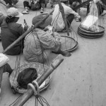 CAMBODIA, Poipet (Banteay Meanchey). 17/06/2014: Peddlers waiting for the border gates to open. They have a special daily permit, unlike the hundreds of thousands of Cambodians working in Thailand. In a massive movement of fear, some 180.000 cambodian migrant workers, many of them illegal, return home in one week time after the military coup in Thailand which vowed to normalise the situation of illegal immigration.