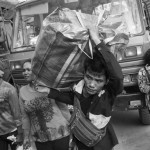 CAMBODIA, Poipet (Banteay Meanchey). 17/06/2014: Migrants who just disembarked from trucks provided by the Thai authorities. In a massive movement of fear, some 180.000 cambodian migrant workers, many of them illegal, return home in one week time after the military coup in Thailand which vowed to normalise the situation of illegal immigration.