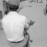 BELGIUM. Blankenberge. 25/07/1978: Man with small dog on the promenade.