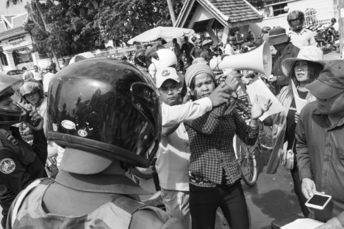 CAMBODIA, Phnom Penh. 14/07/2014: Municipal security guards try to confiscate a bullhorn from a member from the Boeung Kak lake community, embroiled in a 7-year-long land dispute, when demonstrating in front of the Phnom Penh Municipality, requesting a resolution to their problem.