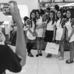 CAMBODIA, Phnom Penh. 1/07/2014: Souvenir photograph with the Chat'ime hostesses on the first official opening day of the Aeon mall, a 205 million dollar investment by a Japanese microfinance company.