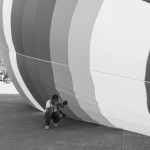 CAMBODIA, Phnom Penh. 1/07/2014: Pring Samrang, photojournalist, photographing Andrew Parker, a hot air balloon pilot who travels to 100 different locations with the Flying High For Kids World Balloon Project for Unicef, prepare his aircraft.