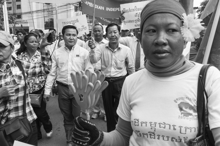 CAMBODIA, Phnom Penh. 5/10/2014: Head of the CNRP Youth, next to Rong Chhun, leader of the teacher's union, marching to the Ministry of Education during a demonstration on World Teacher Day.