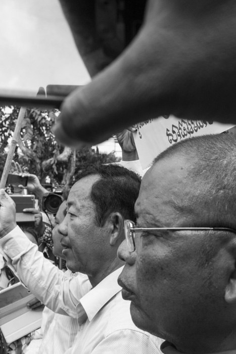 CAMBODIA, Phnom Penh. 5/10/2014: Rong Chhun, leader of the teacher's union, and a buddhist leader stopped at a police barricade in front of the Ministry of Education during a demonstration on World Teacher Day.